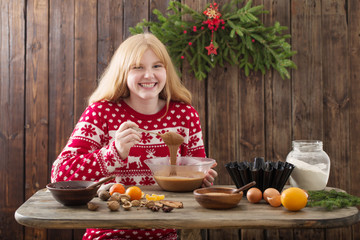 happy girl cooking Christmas cake