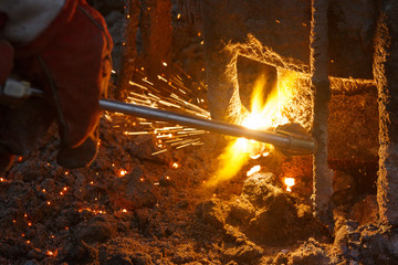 Welding machine with melting metal drops and sparks of sparks.