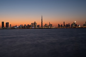 Fototapeta na wymiar Dubai slyline from Dubai Creek Harbour and Dubai canal to Downtown and Business Bay, United Arab Emirates
