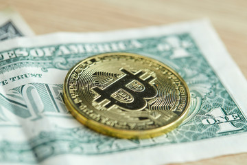 Golden Bitcoin coin on wood background