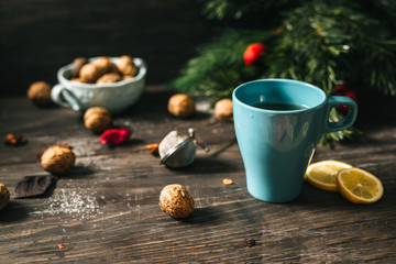 horizontal image of cup of tea on rustic wooden table, christmas decorated