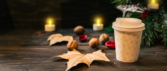 cup of coffee in paper cup on christmas decorated table