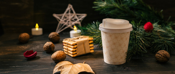 cup of coffee in paper cup on christmas decorated table
