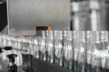 empty plastic bottles on conveyor belt. equipment at the dairy plant