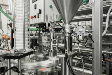 production and bottling of yogurt in plastic cups. equipment at the dairy plant