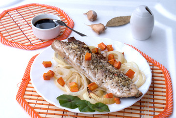 Baked trout fish on coals with onions and carrots, Russian cuisine, top view
