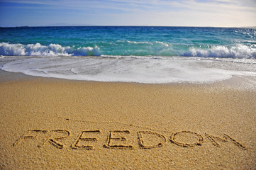 Freedom sign on the sand beach
