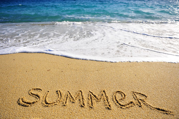 Summer sign on the sand beach