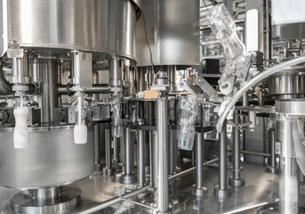 filling milk in to plastic bottles at the factory. equipment at the dairy plant