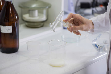 woman testing samples of dairy products in the laboratory. test laboratory of a milk factory