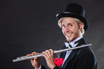 Male flutist with flute and heart. Love melody © anetlanda