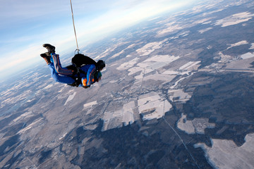 Skydiving. Tandem jump with happy girl.