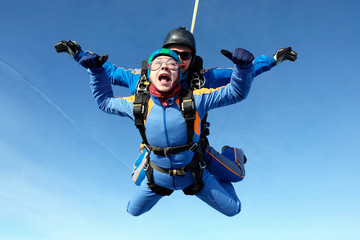 Skydiving. Tandem jump with happy girl.