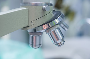 Close-up shot of microscope with metal lens at laboratory.