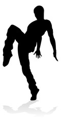 A male street dance hip hop dancer in silhouette