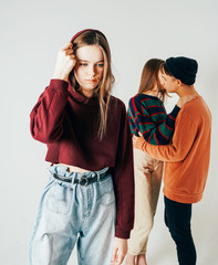 Sad young teen girl on background of loving couple, isolated. Th