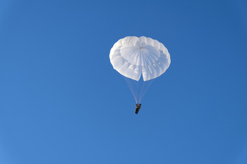 A military paratrooper is landing.
