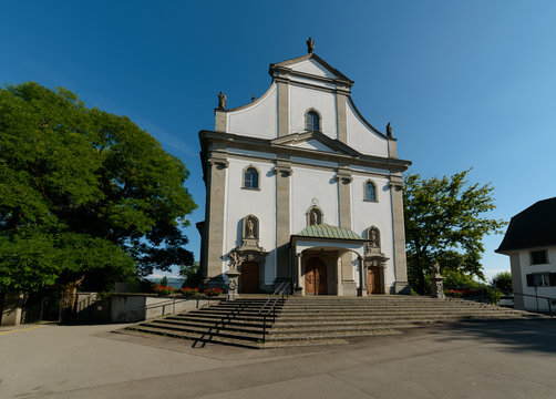 Close-up of catholic Saint Jacob cathedral church kirche in Cham town (Zug, Switzerland) on the clear blue sky background on a summer day