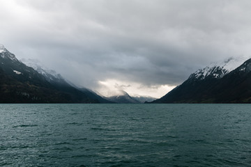 Panoramic view from Brienz village town city on Morgenberhorn mountain spot-lit with the sun through dramatic thunder clouds