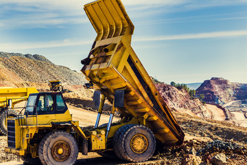 Yellow dump truck lifted in the mine