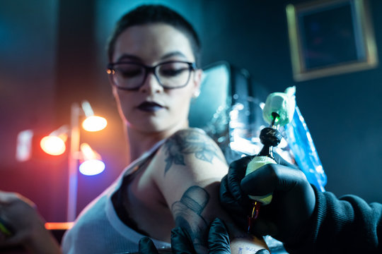 Portrait Of Rocker Beautiful Girl Getting Tattoo In Beauty Parlor
