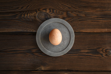  brown egg on round concrete slab