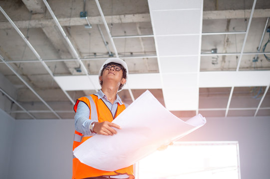 Asiatic engineers are work inspecting the building interior.