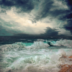 Stormy sea view  near coastline at evening time. Waves, splashed 