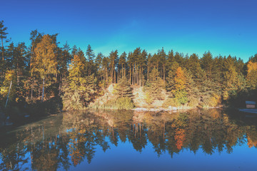 Fototapeta premium Aerial view of the beautiful lake in the autumn forest