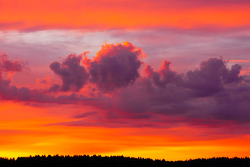 Bright morning sky with flaming red, orange and purple clouds