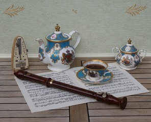 English teacup with saucer, teapot and sugar bowl, fine bone china porcelain, metronome for music...