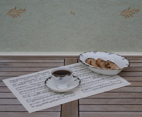 English teacup with saucer and a cake bowl with cookies, fine bone china porcelain, on a sheet of...