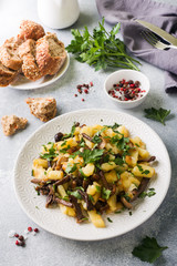 Fried potatoes with mushrooms and fresh herbs.