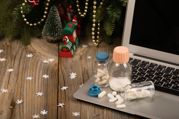 Set of medication on laptop.