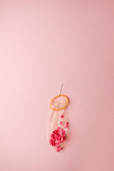 condom filled with confetti and confectionary dressing heart-shaped on a pink background - the...