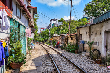 Fototapeta na wymiar Hanoi city railway Perspective view running along narrow street with houses in Vietnam
