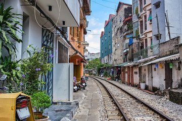 Obraz na płótnie Canvas Hanoi city railway Perspective view running along narrow street with houses in Vietnam