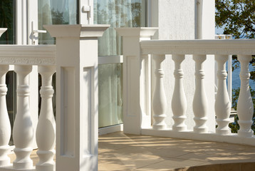 White concrete balustrade of small entrance porch.