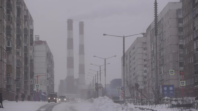Industrial zone with a large red and white pipe thick white smoke is poured Norilsk 2018