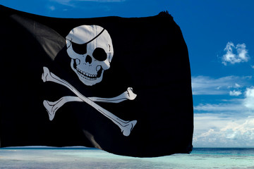 waving pirate flag jolly roger on tropical island background