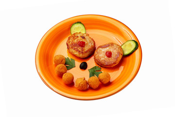 Plate of meat cutlets and nuggets for children menu layed as a funny face  isolated at white...