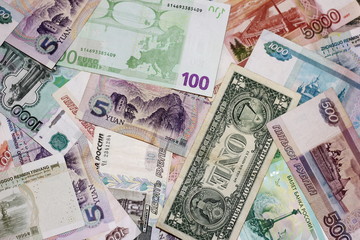 Banknotes of different countries are a bunch of alternately. Rubles, dollar, Euro, yuan. The concept of international business and tourism.