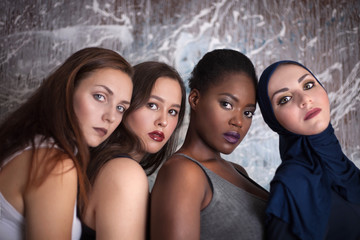 Portrait of four girls with different skin color and nationality in the studio