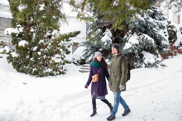 Happy Young Couple in Winter Park having fun.