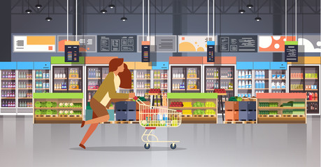 running business woman customer with shopping trolley cart busy female shopper buying products grocery market interior flat horizontal - obrazy, fototapety, plakaty