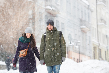 Happy Young Couple in Winter city having fun.