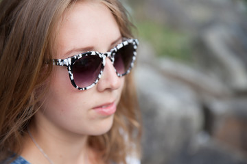 beautiful young blond woman with sunglasses in the nature summer