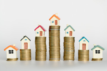 Mini house on stack of coins,Money and house,  Mortgage, Savings money for buy house and loan to...