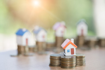Mini house on stack of coins,Money and house,  Mortgage, Savings money for buy house and loan to...