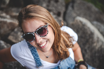 beautiful young blond woman with sunglasses in the nature summer